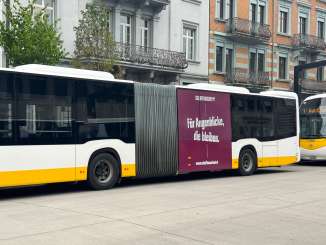 Ein Bus ist mit Werbung aus dem Schaffhauserland foliert. Es steht auf einer purpur-farbigen Fläche "Für Augenblicke, die bleiben.".
